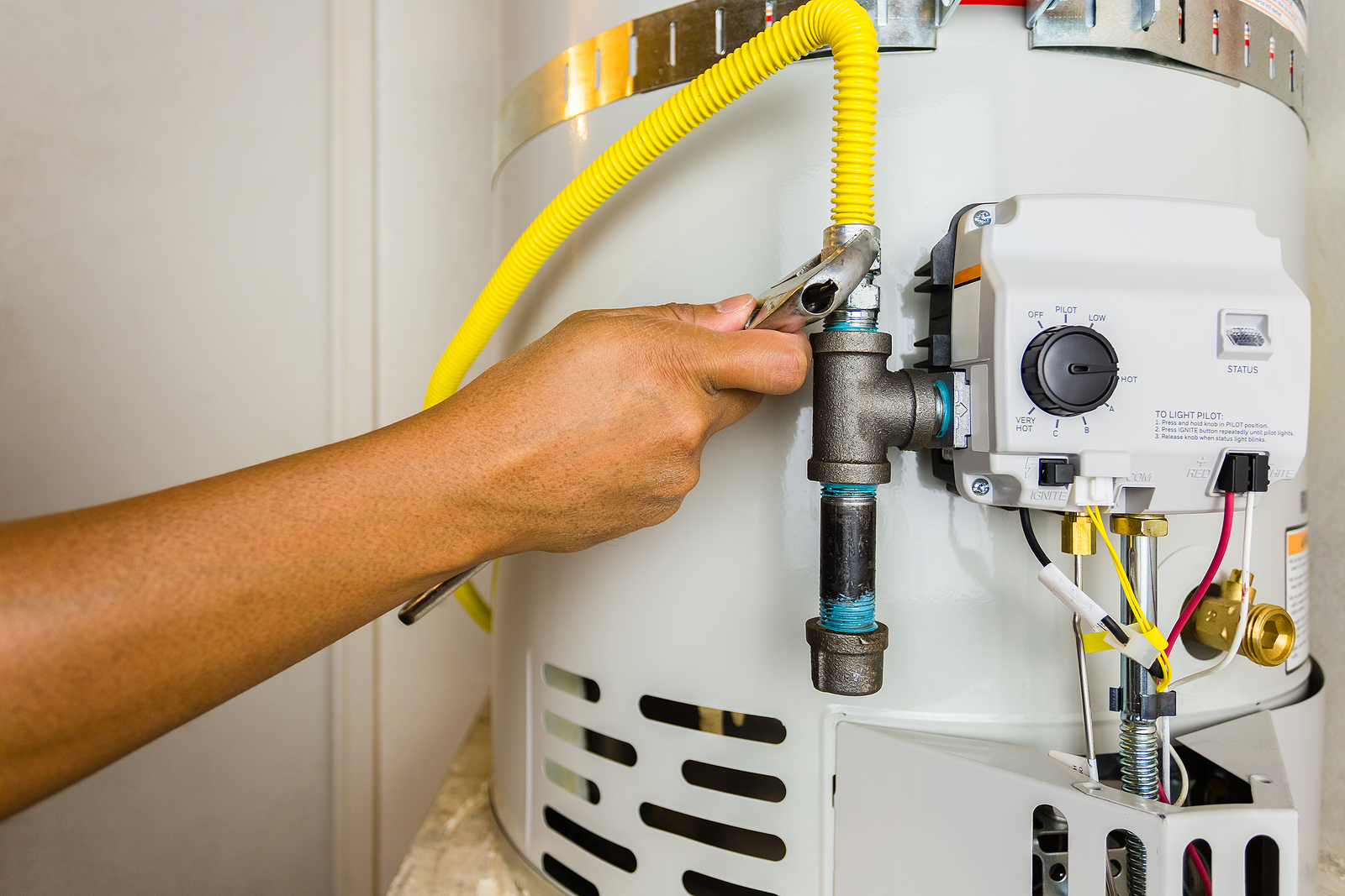 Plumber Installing A Gas Line On A Newly Installed Water Heater